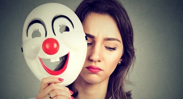 Bipolar disorder - Woman holding mask