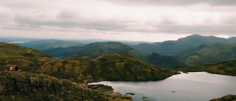A view of stickle tarn in the Lake District, a tarn on a plateau up in the mountains of Landale valley, with mountains sprawling behind it