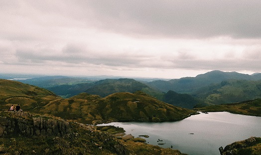 A view of stickle tarn in the Lake District, a tarn on a plateau up in the mountains of Landale valley, with mountains sprawling behind it