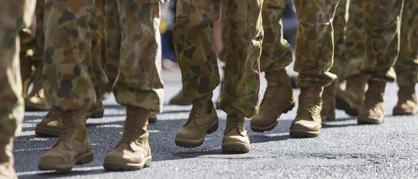 line of legs marching, dressed in armed forces uniform