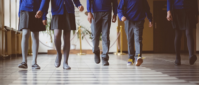 children walking down a school hallway