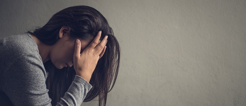 woman in profile with her head in her hands