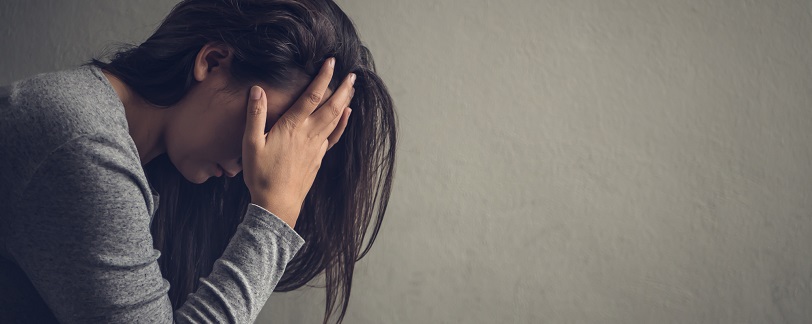 woman in profile with her head in her hands