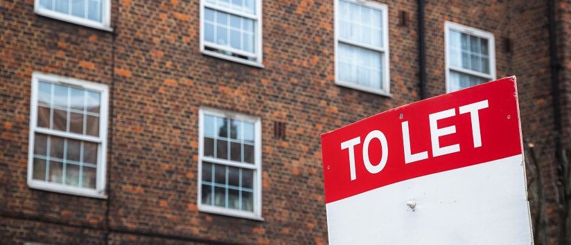 image of flats with to rent sign outside rental 