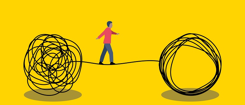man walking across tight rope to symbolise problem solving